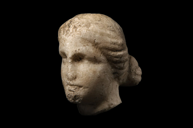 A fragmentary Greek marble head of a goddess. Circa 1st – 2nd century AD. Price realised £850