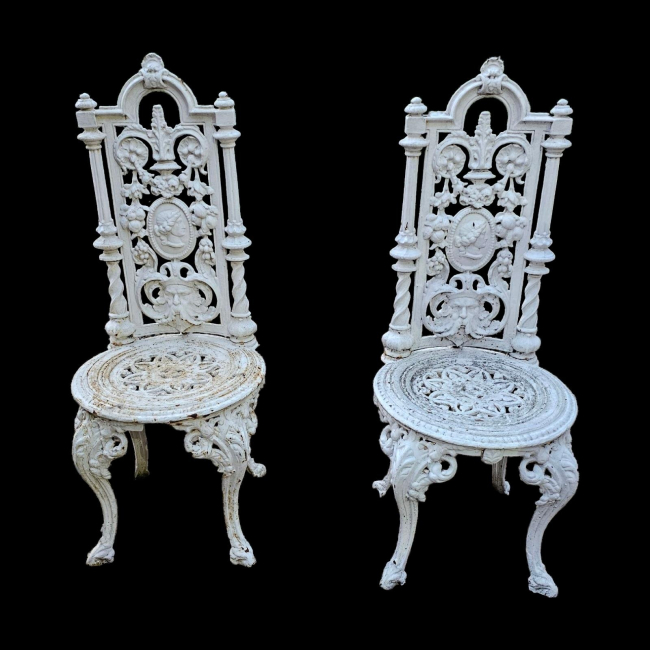 A PAIR OF VICTORIAN HEAVY CAST IRON GARDEN CHAIRS